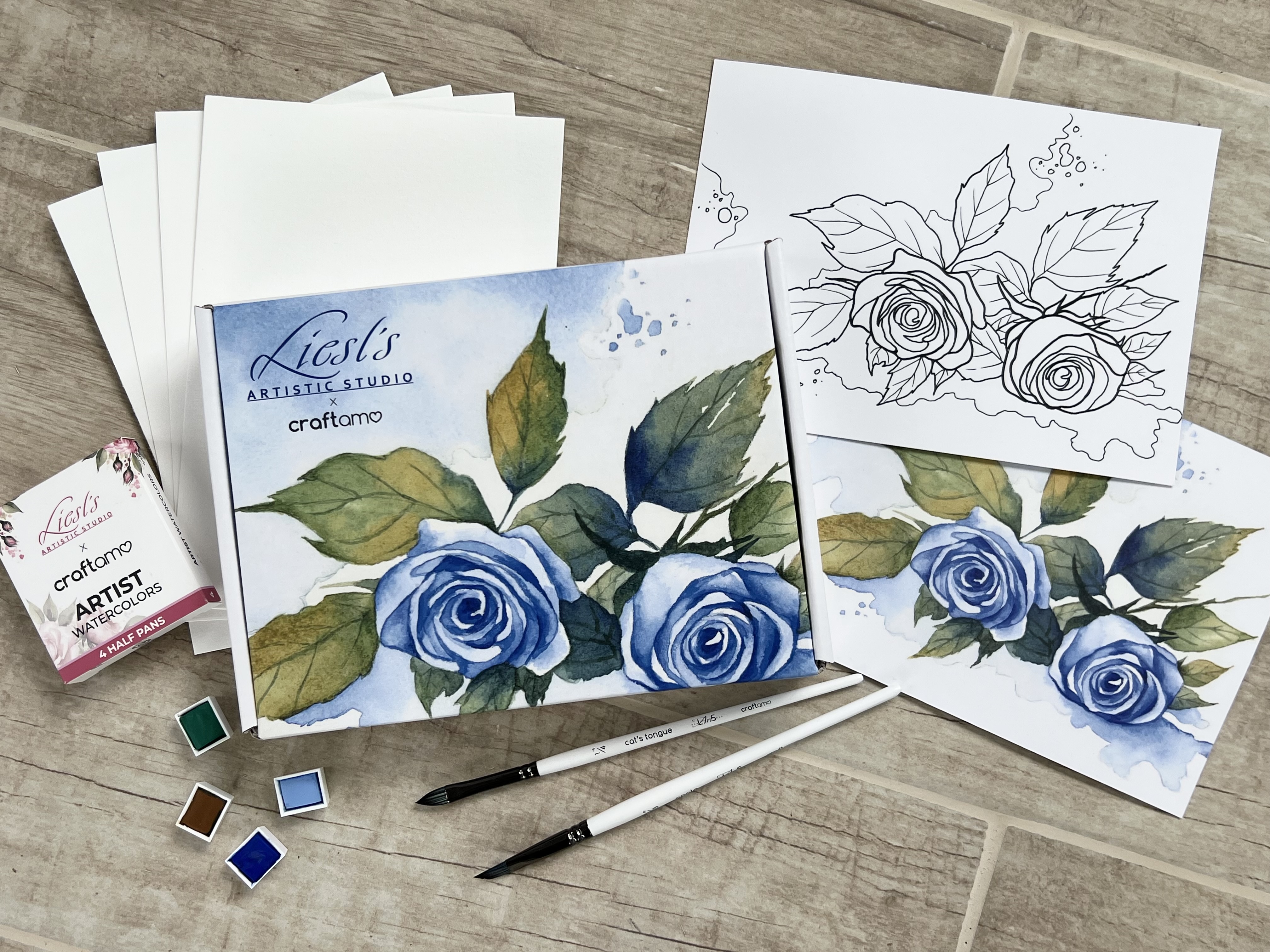 Watercolor tools and paper in the blue flower box